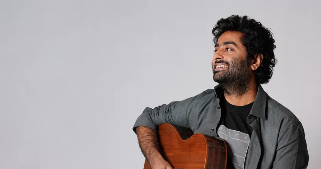 Arijit Singh biography – Indian playback singer holding a guitar