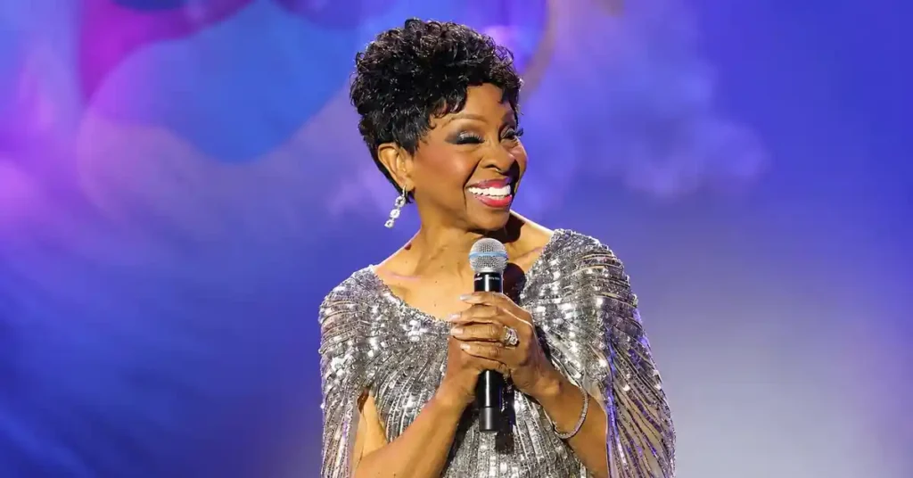 Gladys Knight smiling onstage with a microphone for the Gladys Knight husband profile