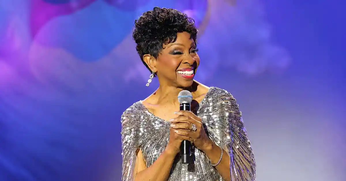 Gladys Knight smiling onstage with a microphone for the Gladys Knight husband profile