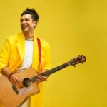 Jubin Nautiyal net worth 2026 – Indian singer holding an acoustic guitar