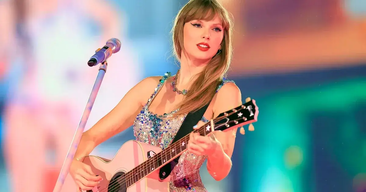 Taylor Swift Height performing on stage with a guitar during The Eras Tour