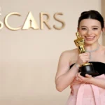 Mikey Madison height holding an Oscar statuette and personal profile article